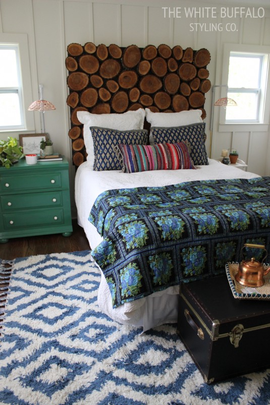 rustic-bohemian-master-bedroom with wooden headboard