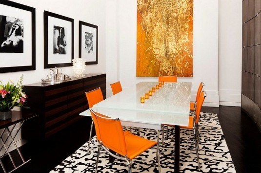 modern-dining-room-design-with-orange-chairs-and-sleek-white-table-also-golden-abstract-painting