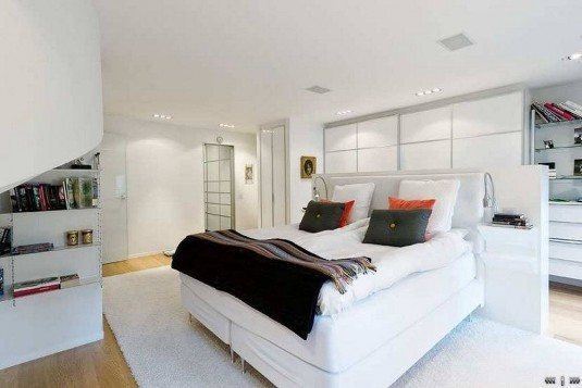 Charming-bedroom-design-with-comfy-white-upholstered-double-bed-also-white-area-rug-and-laminate-flooring