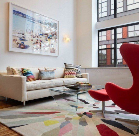 Light-Filled-Duplex-living-area-interior-with-colorful-rug-and-Red-Egg-Chair-also-glass-coffee-table-and-white-comfy-sofa-design-ideas-1024x999