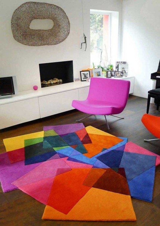 White-Living-Room-with-Pink-Chair-and-Colorful-Rugs