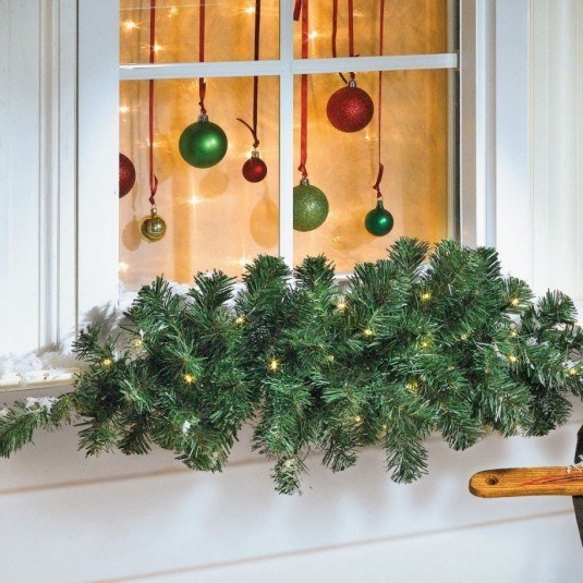 White-christmas-window-with-red-and-green-colored-of-balls-also-some-beautiful-green-plants-with-a-little-yellow-lamp-915x915