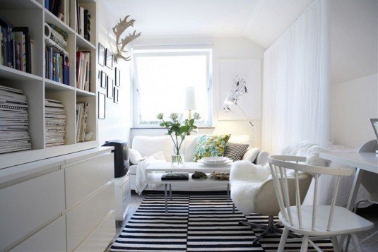 minimalist-scandinavian-interior-design-with-white-painted-oak-wood-book-shelves-and-white-painted-teak-wood-chair-also-white-stripe-black-area-carpet-945x630