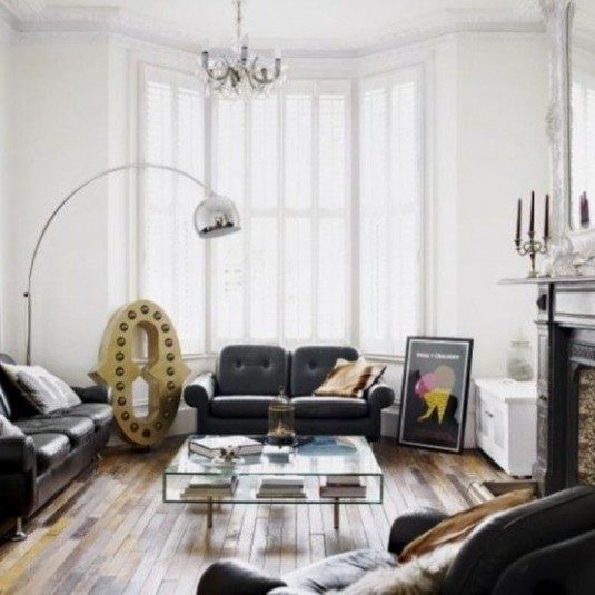 Awesome-Typical-British-Interior-With-white-black-wall-sofa-brown-pillow-glass-table-fireplace-candle-mirror-lamp-chandelier-hardwood-floor