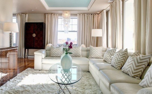 condo-interior-design-featured-pretty-living-room-with-fur-rug-also-glass-coffee-table-and-chevron-sofa-pillows