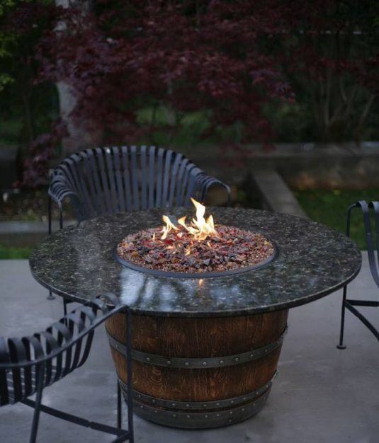 A-fire-burns-in-an-old-wine-barrel-repurposed-as-a-fire-pit