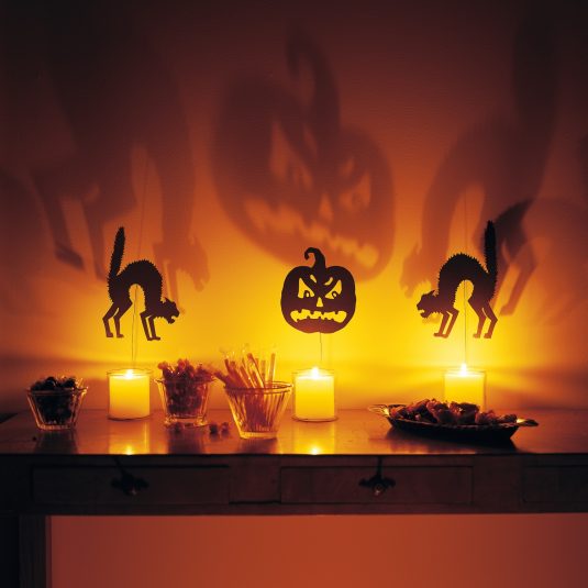 remarkable-table-design-with-three-paper-craft-beside-the-candle-and-make-scary-sahdow-complete-with-sweet-candies-and-cake-for-halloween-event